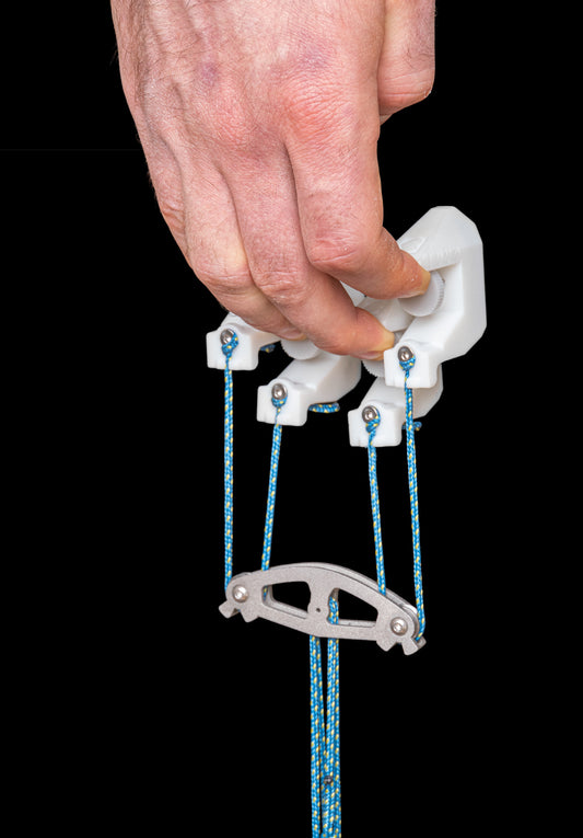 Hand holding the funky fingers finger trainer in an open hand